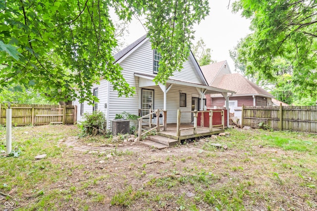 525 N Concord St N, Indianapolis, IN 46222 - rear view of house with a fenced backyard, a wooden deck, and a shingled roof