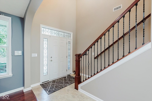 823 Colin Dr, Avon, IN 46123 - foyer featuring arched walkways, stairs, and a towering ceiling