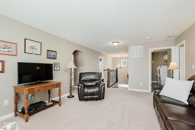 823 Colin Dr, Avon, IN 46123 - living room featuring independent washer and dryer, a chandelier, and light colored carpet