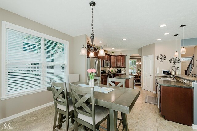 823 Colin Dr, Avon, IN 46123 - dining space with arched walkways, recessed lighting, and light tile patterned floors