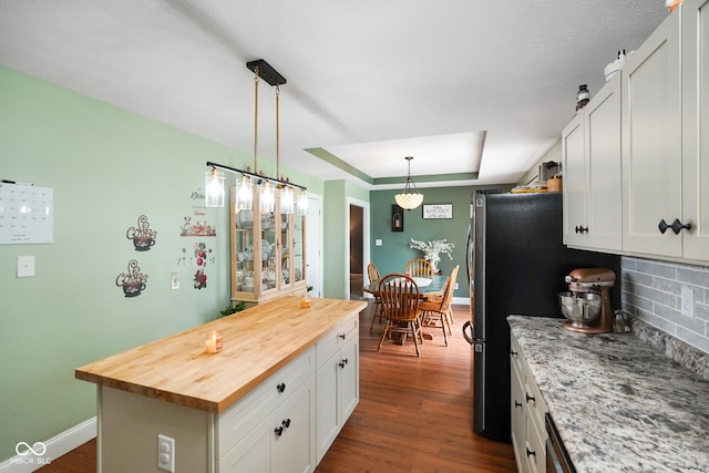 6020 E Smokey View Rd, Mooresville, IN 46158 - kitchen featuring butcher block counters, a kitchen island, tasteful backsplash, white cabinets, and dark wood-style flooring