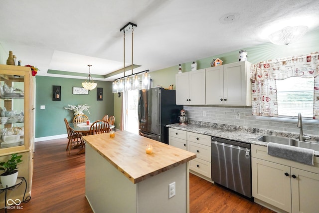 6020 E Smokey View Rd, Mooresville, IN 46158 - kitchen featuring appliances with stainless steel finishes, butcher block countertops, a center island, a raised ceiling, and decorative backsplash
