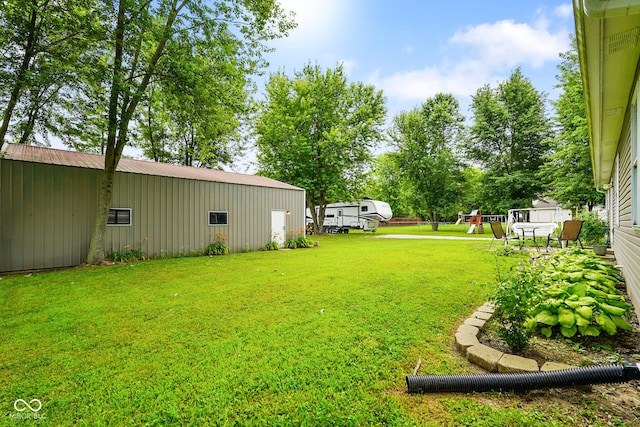 6020 E Smokey View Rd, Mooresville, IN 46158 - view of green lawn featuring a pole building, an outbuilding, and a playground