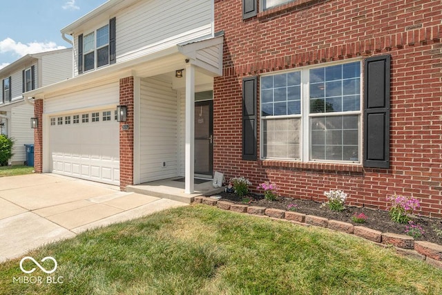 10450 Wintergreen Way, Indianapolis, IN 46234 - doorway to property featuring brick siding, concrete driveway, and a garage