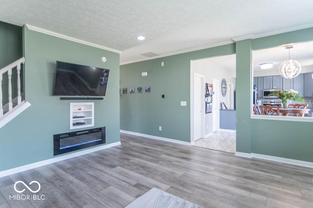 10450 Wintergreen Way, Indianapolis, IN 46234 - unfurnished living room with ornamental molding, a textured ceiling, wood finished floors, recessed lighting, and stairway