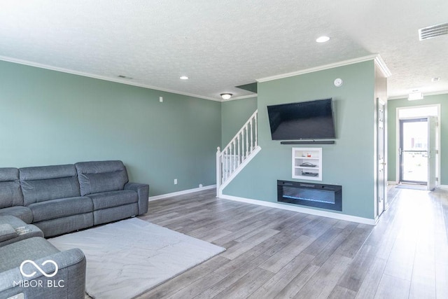 10450 Wintergreen Way, Indianapolis, IN 46234 - living area featuring a textured ceiling, stairs, wood finished floors, ornamental molding, and recessed lighting