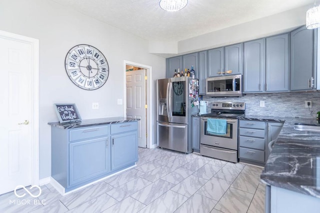 10450 Wintergreen Way, Indianapolis, IN 46234 - kitchen featuring appliances with stainless steel finishes, dark stone countertops, backsplash, a textured ceiling, and light marble finish flooring