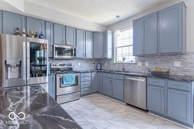 10450 Wintergreen Way, Indianapolis, IN 46234 - kitchen featuring stainless steel appliances, dark stone counters, backsplash, and a textured ceiling
