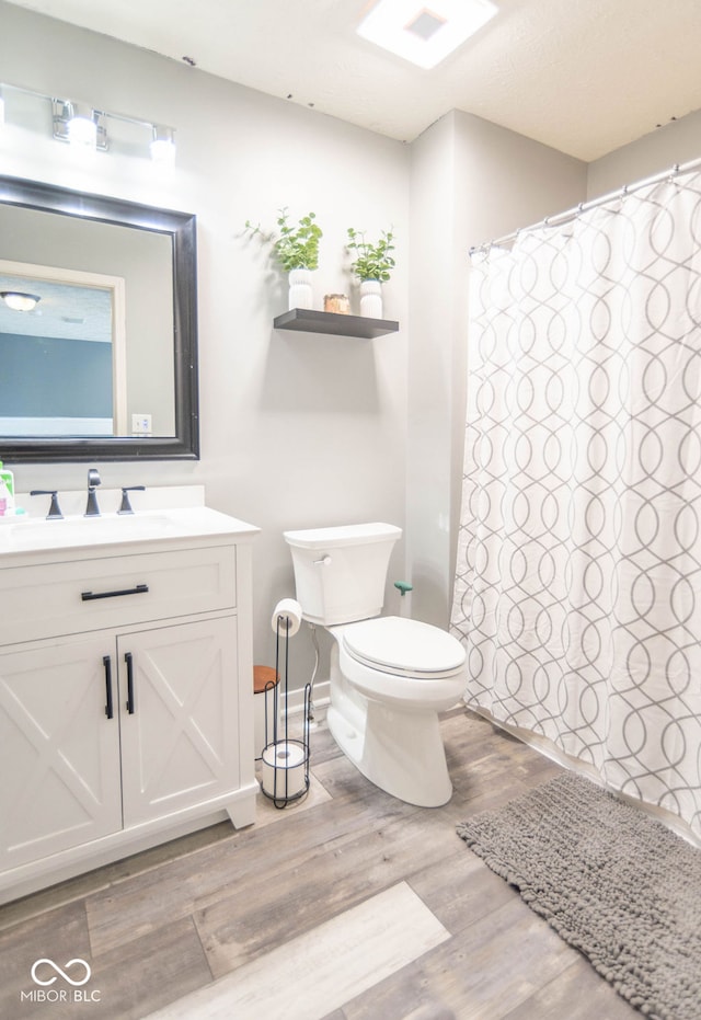 10450 Wintergreen Way, Indianapolis, IN 46234 - bathroom featuring vanity, wood finished floors, and a shower with curtain