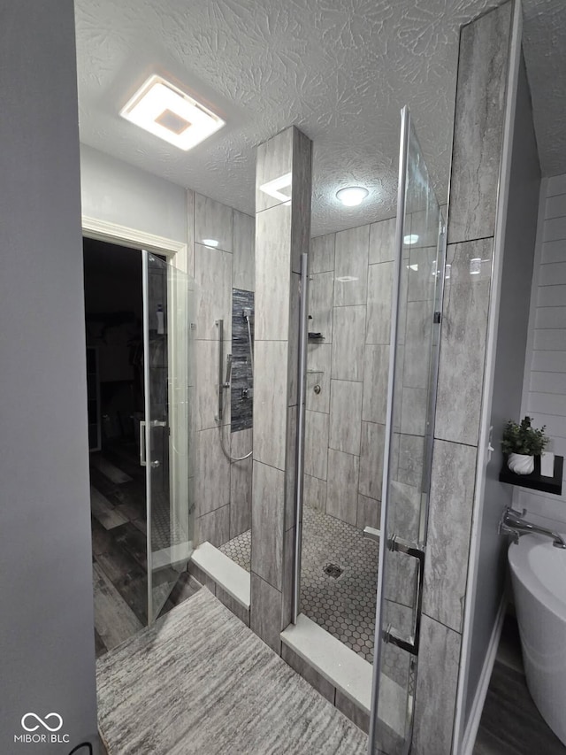 10450 Wintergreen Way, Indianapolis, IN 46234 - full bathroom featuring a shower stall, wood finished floors, a textured ceiling, and a bidet