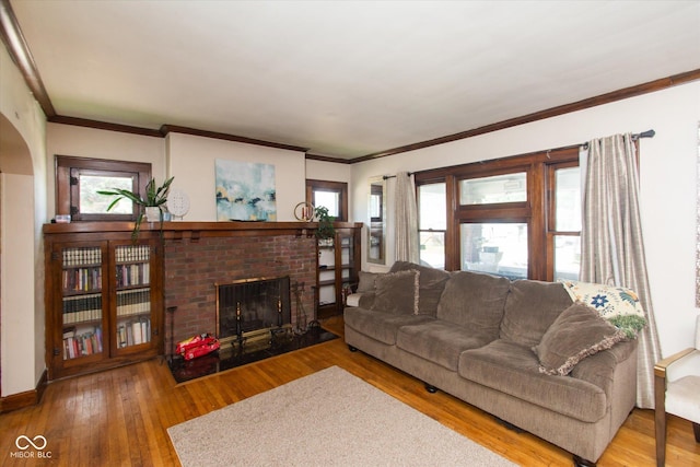 3459 W Michigan St, Indianapolis, IN 46222 - living area with a brick fireplace, healthy amount of natural light, wood finished floors, ornamental molding, and arched walkways