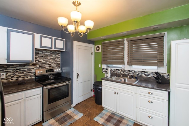 3459 W Michigan St, Indianapolis, IN 46222 - kitchen featuring stainless steel electric range oven, backsplash, dark countertops, and white cabinetry