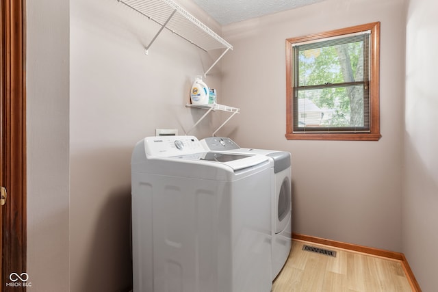 7621 Forest Dr, Fishers, IN 46038 - laundry room with separate washer and dryer and light wood-style flooring