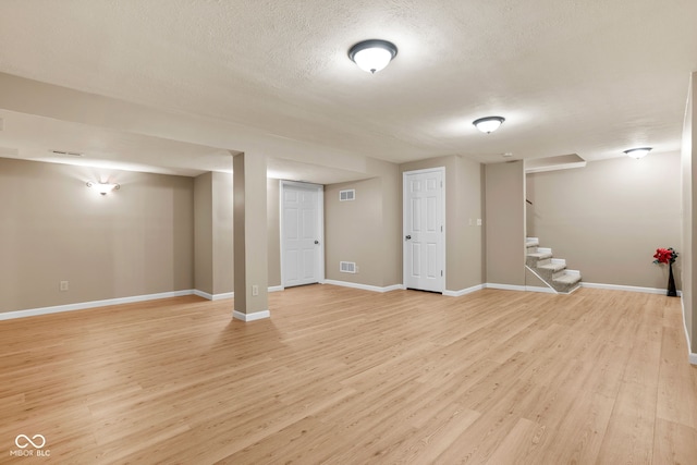 7621 Forest Dr, Fishers, IN 46038 - finished basement featuring light wood-style flooring, stairs, and a textured ceiling