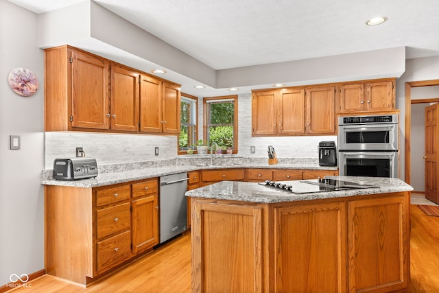 7621 Forest Dr, Fishers, IN 46038 - kitchen featuring stainless steel appliances, light wood-type flooring, tasteful backsplash, and recessed lighting