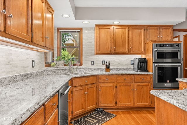 7621 Forest Dr, Fishers, IN 46038 - kitchen with appliances with stainless steel finishes, light wood-type flooring, brown cabinets, decorative backsplash, and recessed lighting