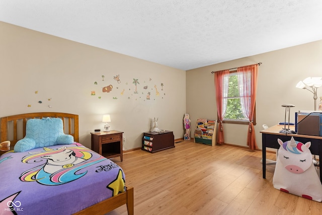 7621 Forest Dr, Fishers, IN 46038 - bedroom featuring light wood-style floors and a textured ceiling