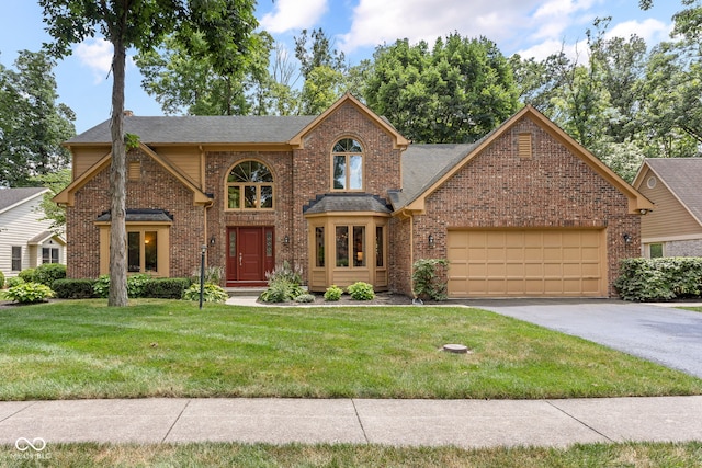 7621 Forest Dr, Fishers, IN 46038 - traditional home with brick siding, an attached garage, asphalt driveway, and a front yard
