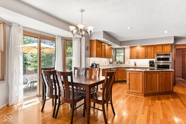 7621 Forest Dr, Fishers, IN 46038 - dining space featuring a chandelier, light wood-type flooring, recessed lighting, and a textured ceiling
