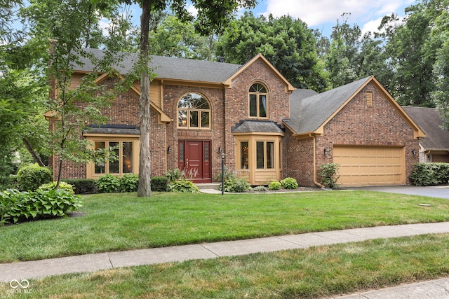 7621 Forest Dr, Fishers, IN 46038 - traditional-style home with brick siding, a shingled roof, an attached garage, a front lawn, and asphalt driveway