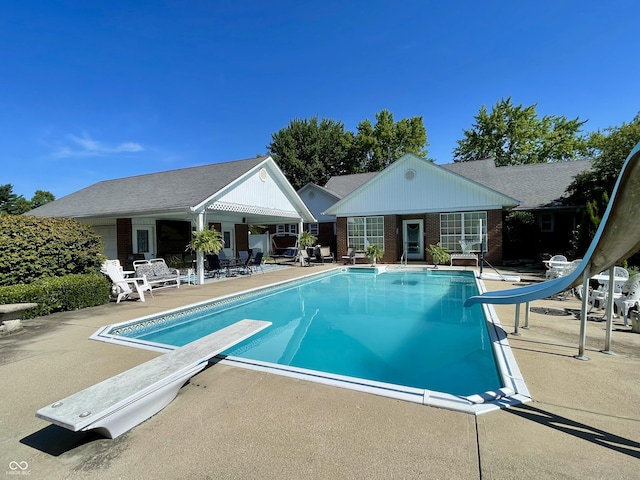 800 Walton Dr, Plainfield, IN 46168 - outdoor pool featuring a water slide, a diving board, a patio, an outbuilding, and a storage structure
