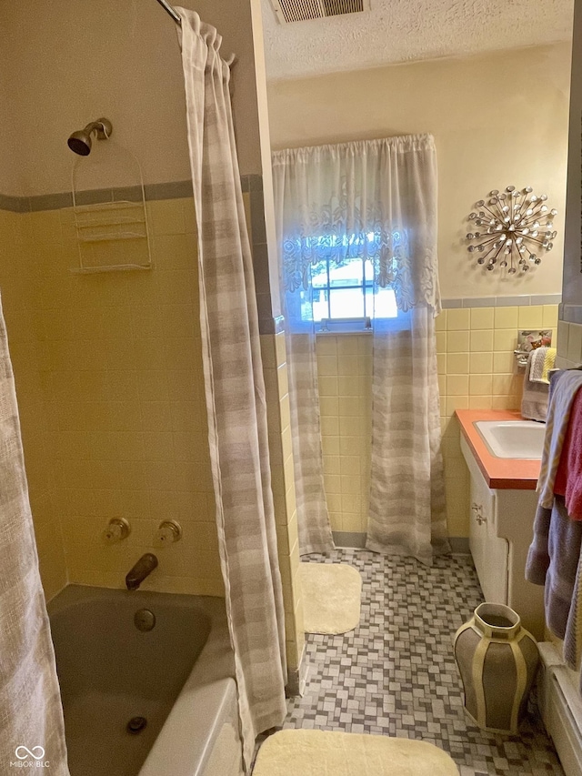 800 Walton Dr, Plainfield, IN 46168 - bathroom with shower / bath combo, wainscoting, tile walls, vanity, and tile patterned floors