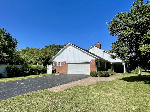 800 Walton Dr, Plainfield, IN 46168 - view of home's exterior with a chimney, brick siding, a lawn, a garage, and asphalt driveway