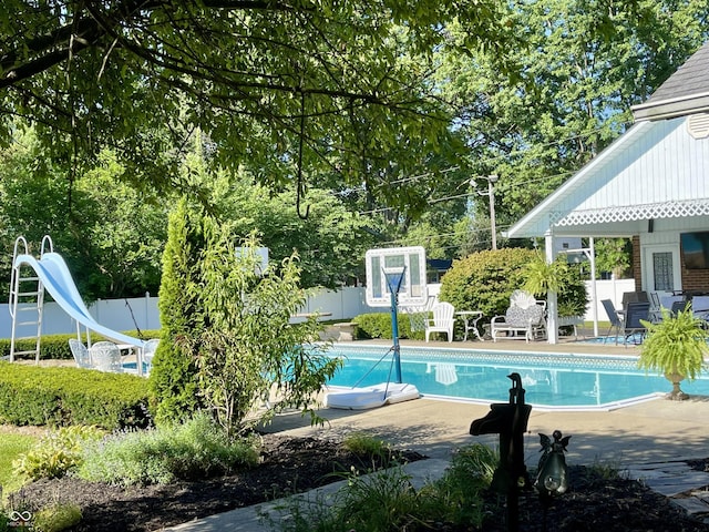 800 Walton Dr, Plainfield, IN 46168 - swimming pool featuring a water slide, a fenced backyard, and a patio area