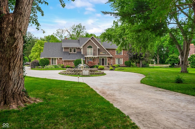 115 Jordan Rd, Indianapolis, IN 46217 - georgian-style home with curved driveway, brick siding, and a front lawn