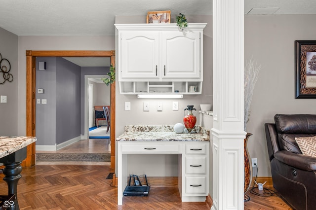 115 Jordan Rd, Indianapolis, IN 46217 - kitchen featuring white cabinets, light stone countertops, open shelves, and built in desk