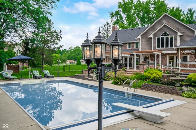 115 Jordan Rd, Indianapolis, IN 46217 - view of swimming pool featuring a patio area, a pergola, and a diving board