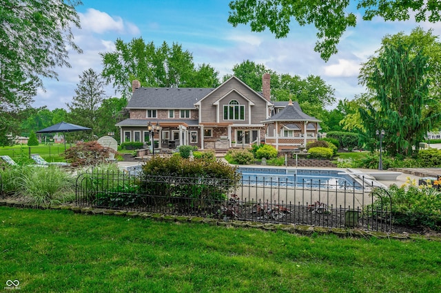 115 Jordan Rd, Indianapolis, IN 46217 - rear view of house featuring a deck, a chimney, a yard, and stone siding