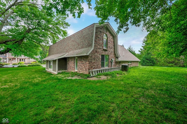 115 Jordan Rd, Indianapolis, IN 46217 - view of side of property featuring roof with shingles, a yard, and brick siding