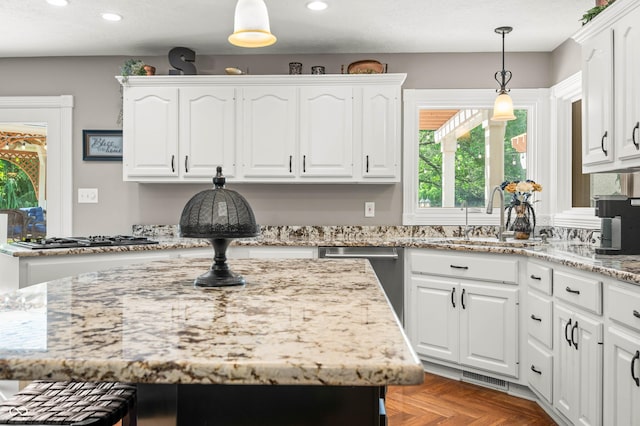 115 Jordan Rd, Indianapolis, IN 46217 - kitchen with gas stovetop, stainless steel dishwasher, white cabinets, recessed lighting, and light stone counters
