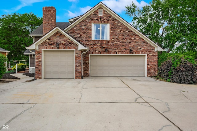 115 Jordan Rd, Indianapolis, IN 46217 - traditional-style home with a chimney, driveway, and brick siding