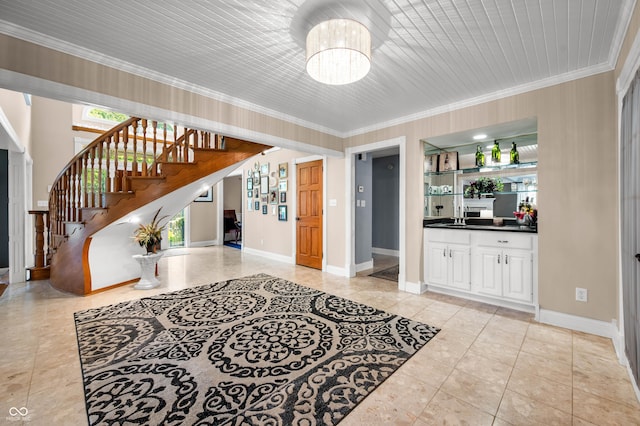115 Jordan Rd, Indianapolis, IN 46217 - entrance foyer featuring a chandelier, ornamental molding, stairs, and light tile patterned floors