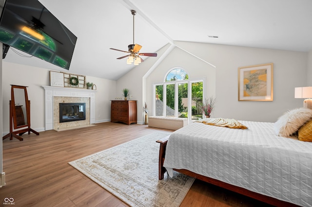 115 Jordan Rd, Indianapolis, IN 46217 - bedroom featuring wood finished floors, lofted ceiling, a fireplace, and a ceiling fan