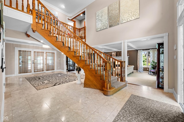 115 Jordan Rd, Indianapolis, IN 46217 - tiled foyer entrance featuring ornate columns, stairs, a high ceiling, crown molding, and recessed lighting