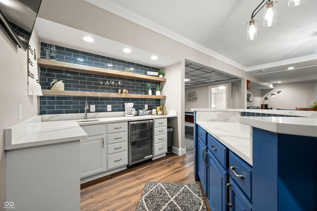 115 Jordan Rd, Indianapolis, IN 46217 - indoor wet bar with wine cooler, wood finished floors, ornamental molding, tasteful backsplash, and recessed lighting