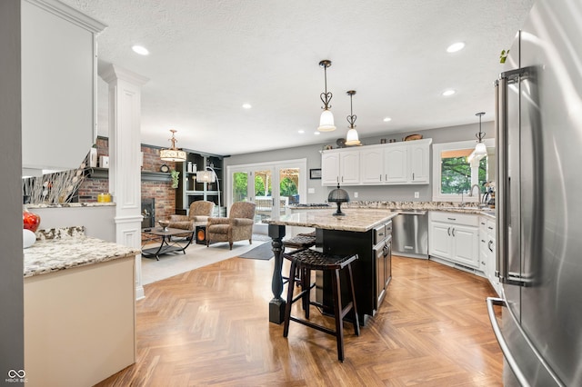 115 Jordan Rd, Indianapolis, IN 46217 - kitchen with appliances with stainless steel finishes, plenty of natural light, white cabinetry, recessed lighting, and a kitchen island