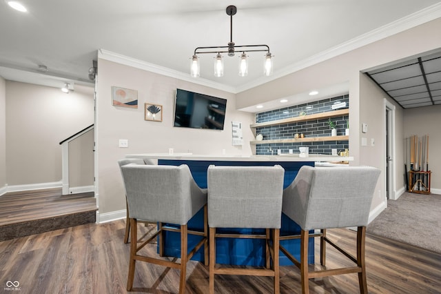 115 Jordan Rd, Indianapolis, IN 46217 - indoor wet bar featuring ornamental molding, dark wood-style flooring, pendant lighting, and recessed lighting