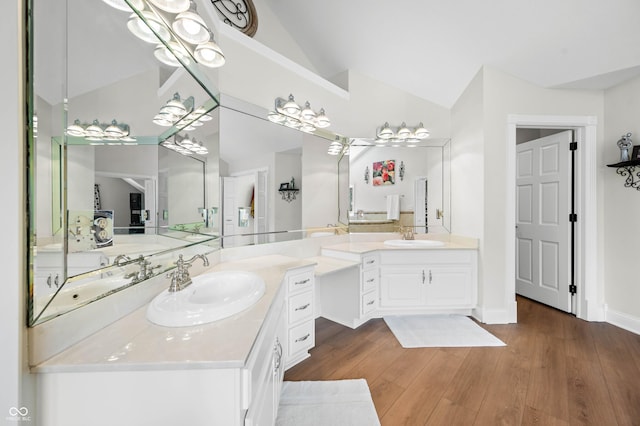 115 Jordan Rd, Indianapolis, IN 46217 - bathroom featuring lofted ceiling, vanity, and wood finished floors