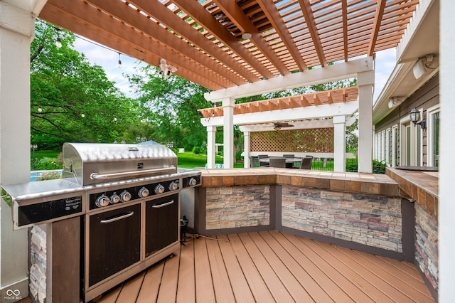115 Jordan Rd, Indianapolis, IN 46217 - deck with a pergola, an outdoor kitchen, and view of wooded area