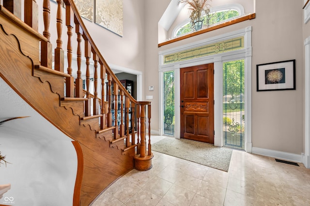 115 Jordan Rd, Indianapolis, IN 46217 - carpeted foyer entrance featuring plenty of natural light, stairway, a towering ceiling, and tile patterned flooring