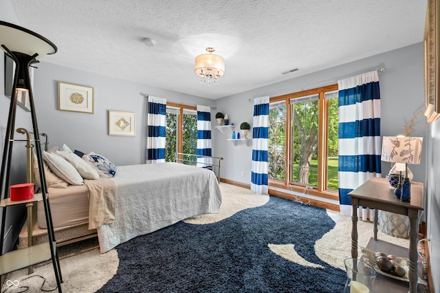 115 Jordan Rd, Indianapolis, IN 46217 - bedroom featuring carpet, multiple windows, and a chandelier
