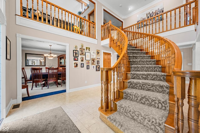 115 Jordan Rd, Indianapolis, IN 46217 - stairway featuring ornamental molding, a chandelier, and a towering ceiling