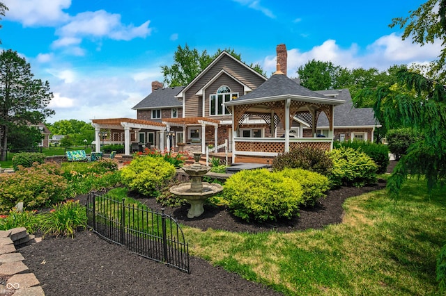 115 Jordan Rd, Indianapolis, IN 46217 - rear view of property featuring a pergola, a gazebo, and a chimney