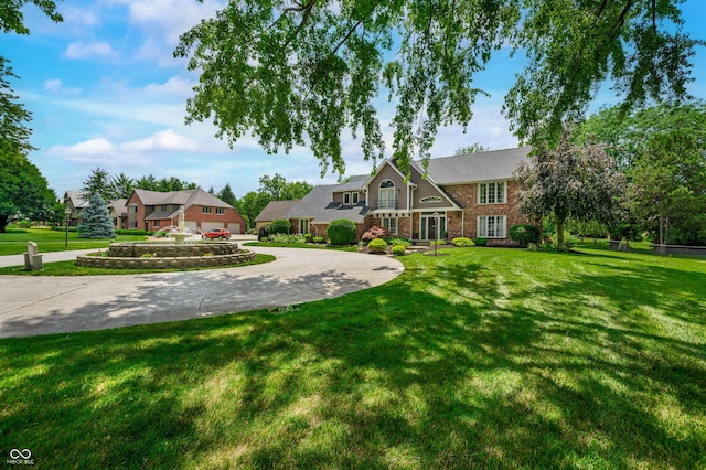 115 Jordan Rd, Indianapolis, IN 46217 - view of front of property featuring curved driveway, a front yard, and brick siding