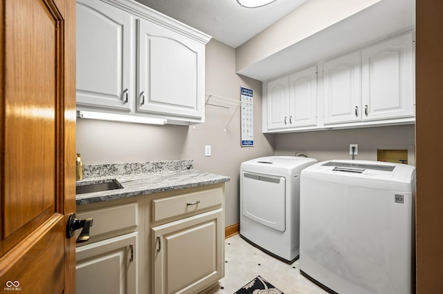 115 Jordan Rd, Indianapolis, IN 46217 - laundry area featuring cabinet space, washing machine and clothes dryer, and light flooring