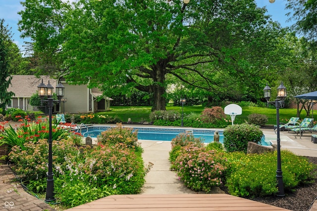115 Jordan Rd, Indianapolis, IN 46217 - swimming pool featuring view of wooded area, a gazebo, and a lawn